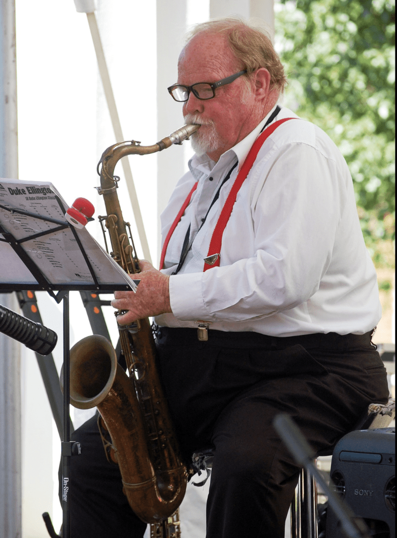 A Man in a White Shirt Playing a Saxophone Two