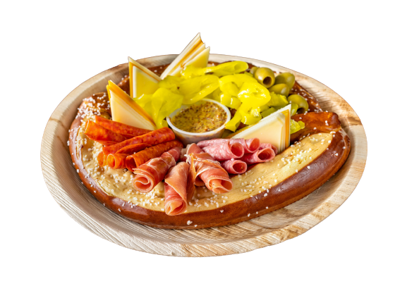 A wooden plate with a variety of meats and vegetables on it.