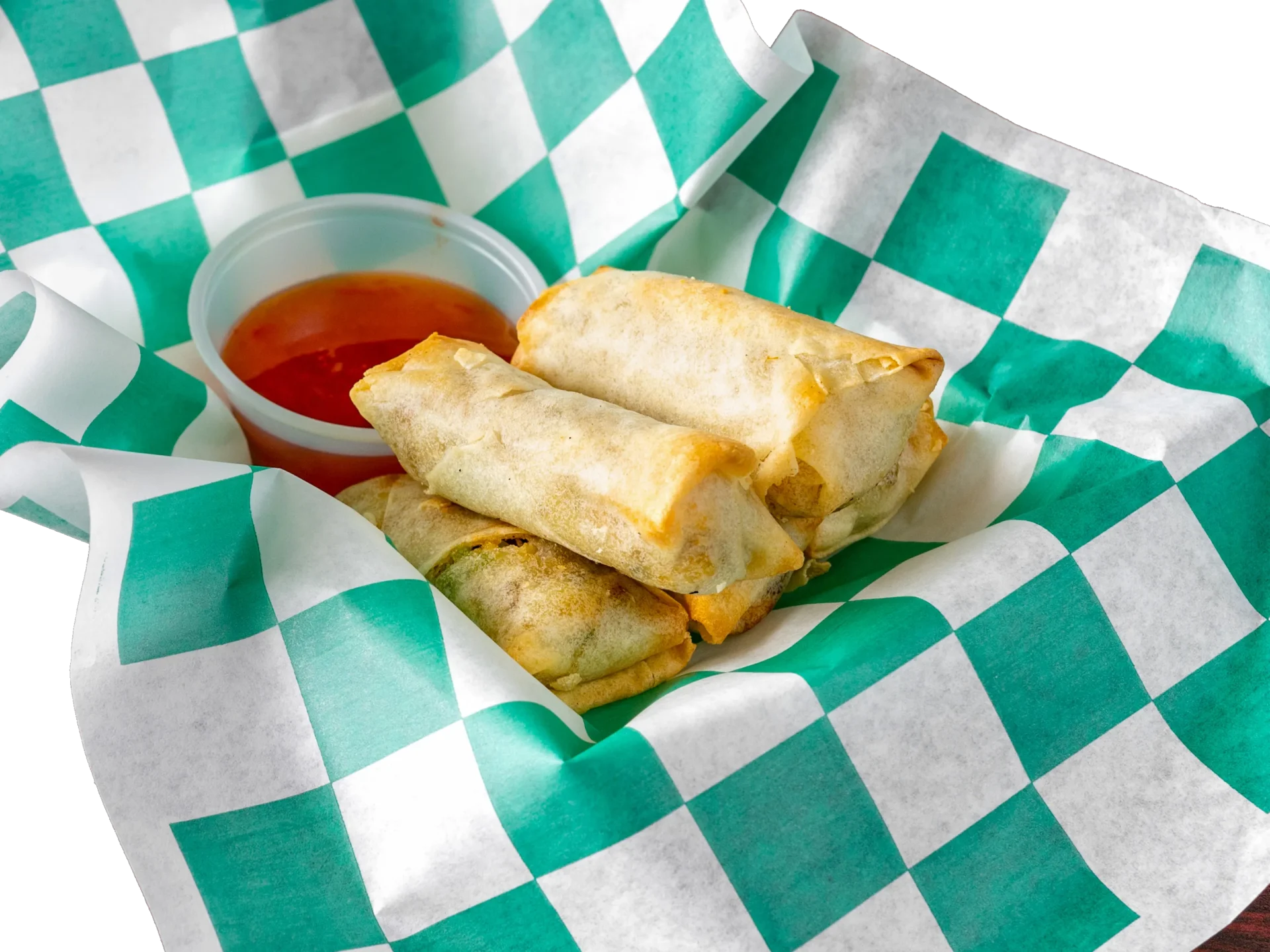 Spring rolls in a green and white checkered paper.