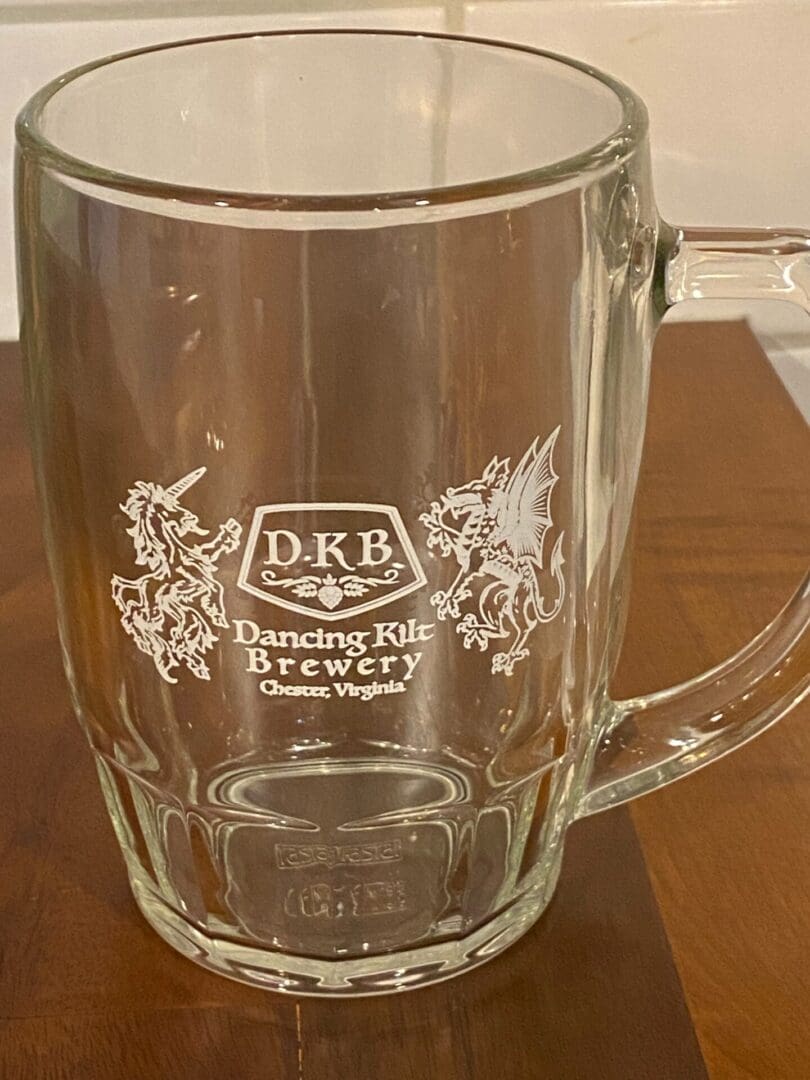 A glass mug with the word dkb on it.