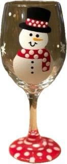A wine glass with a snowman painted on it.