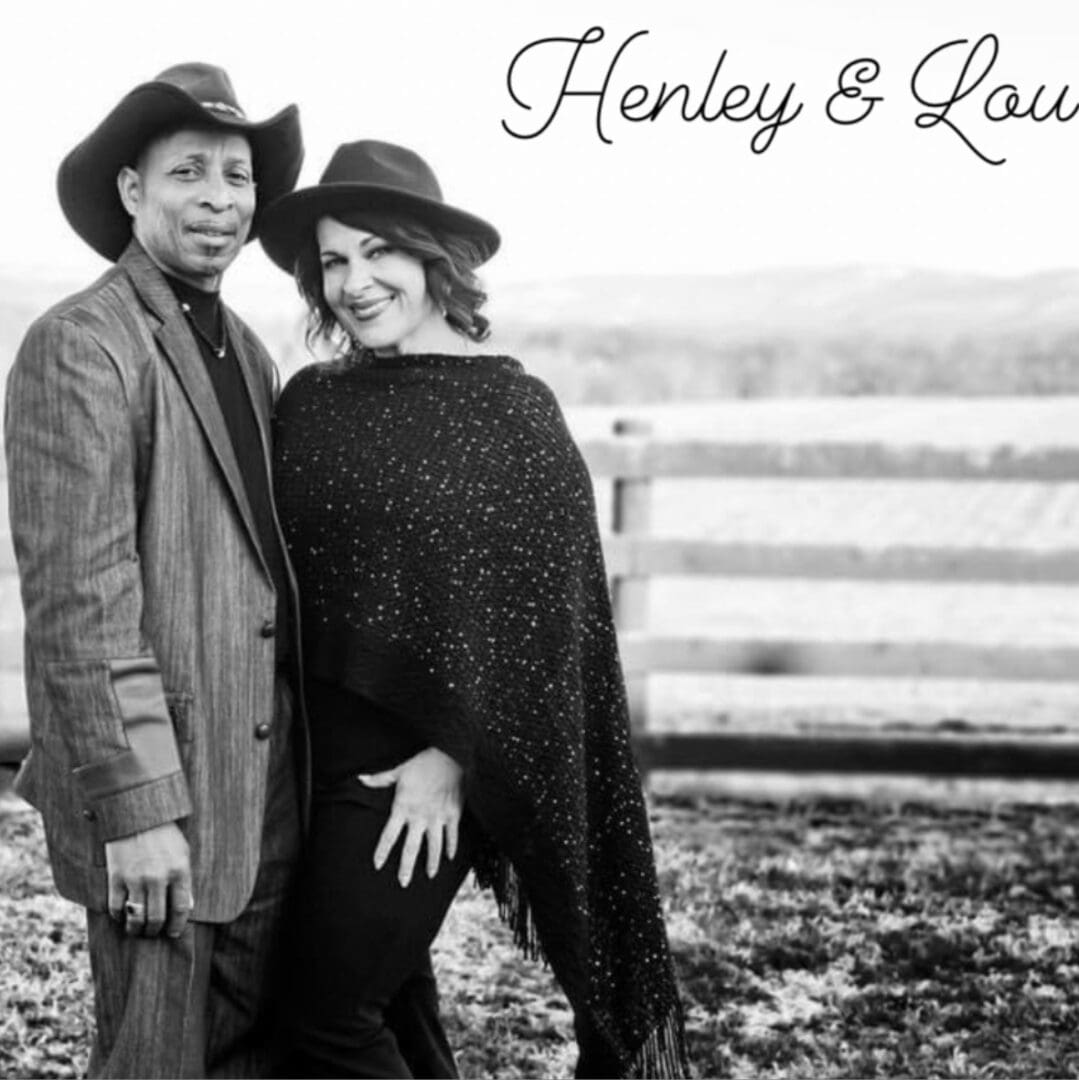 A black and white photo of a couple wearing cowboy hats.